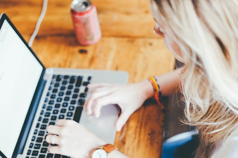 Woman sitting at a table with a laptop